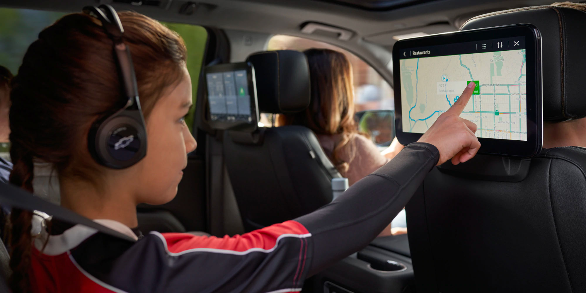 2021 Chevy Suburban girl interacting with Back seat UI