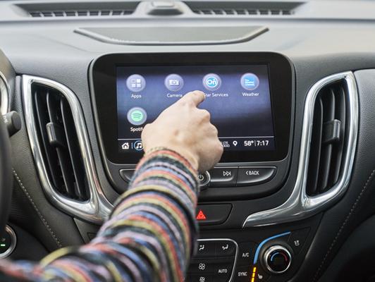 Person pushing button on display with apps Person pushing button on display with apps