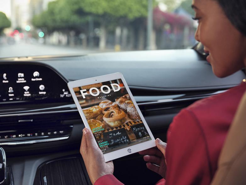 woman using tablet in car