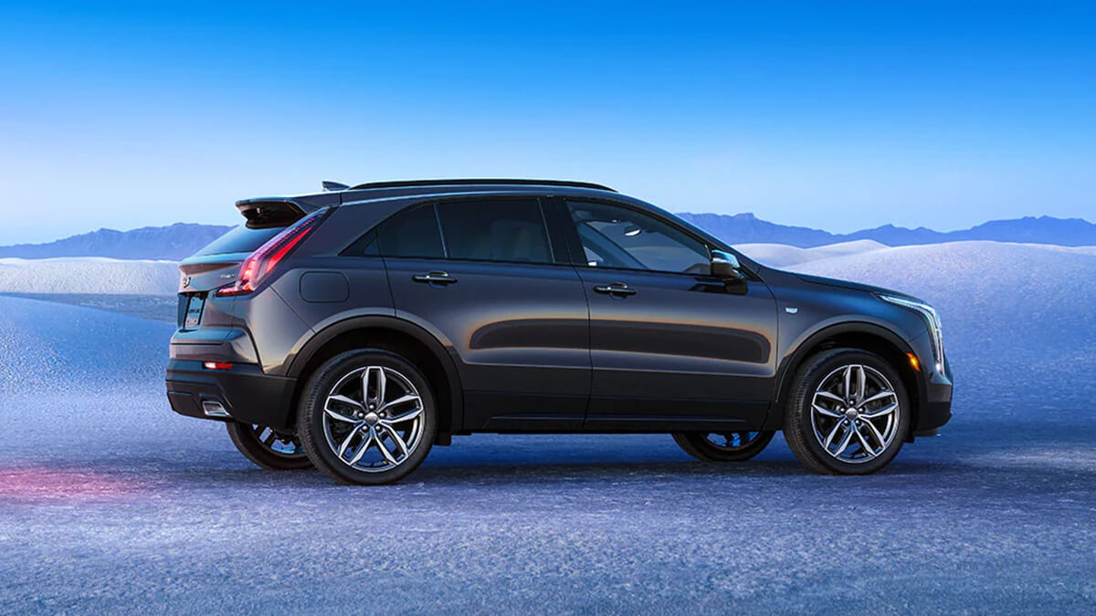 Side view of grey XT4 parked on land covered in ice.