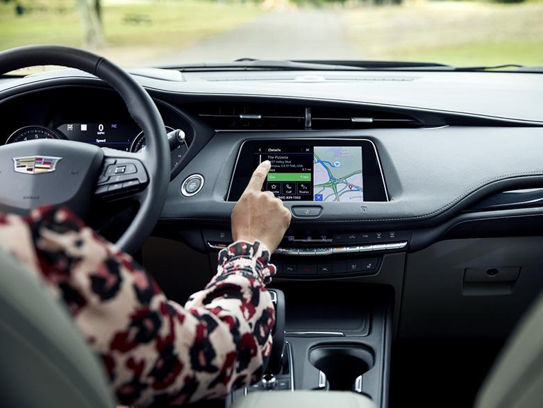 Woman touching screen on cadillac