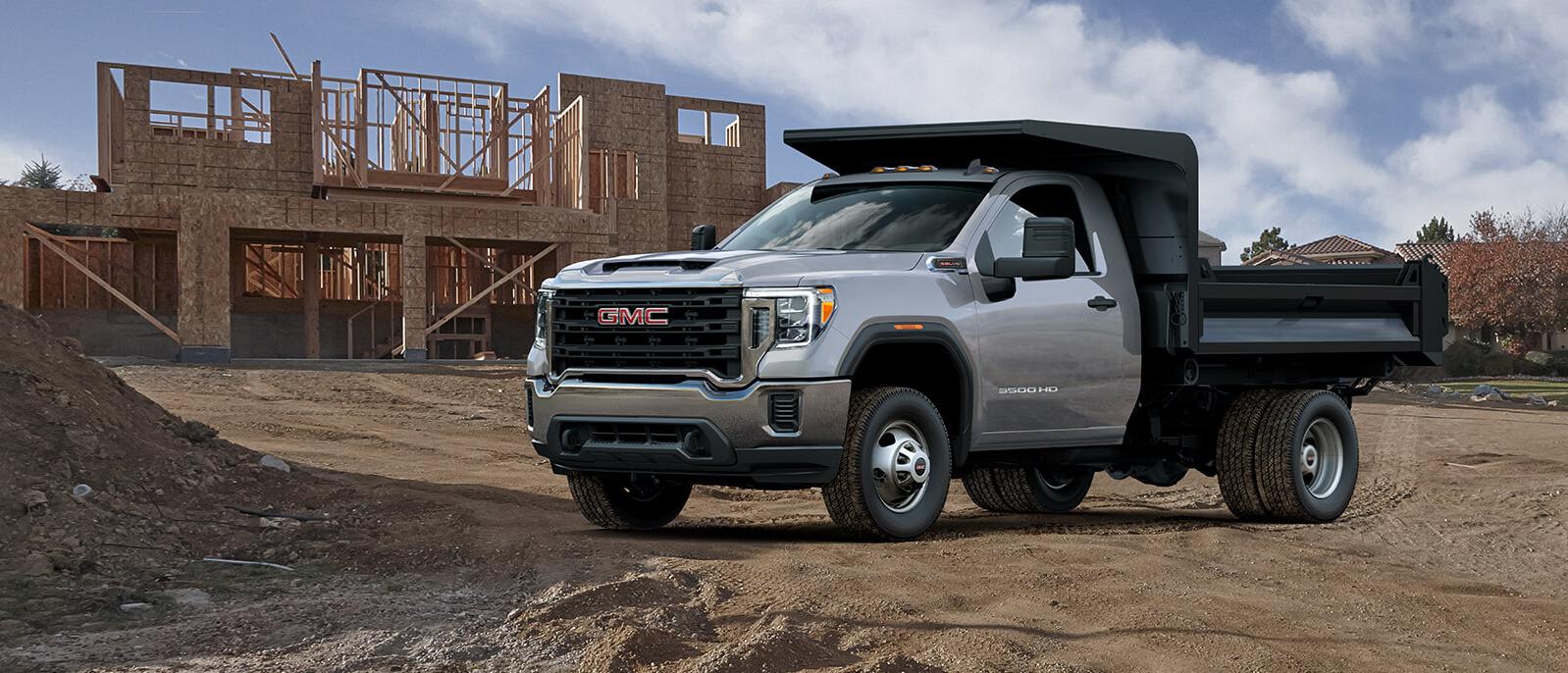 A 2021 GMC Sierra Chassis Cab parked near a construction site. A 2021 GMC Sierra Chassis Cab parked near a construction site.