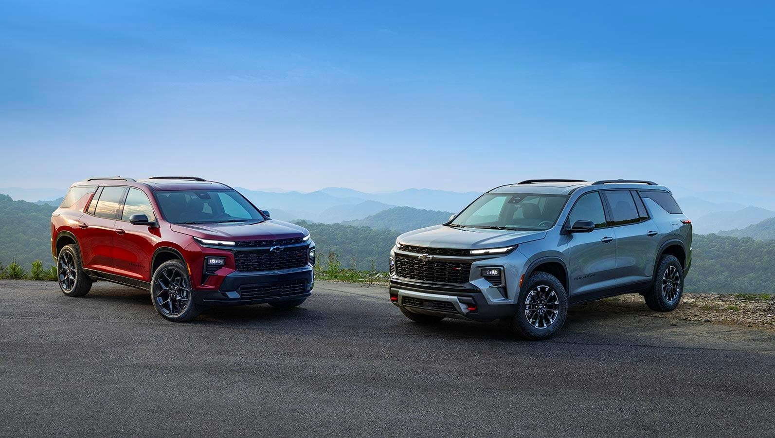 Red and grey Chevrolet Traverse facing each other.