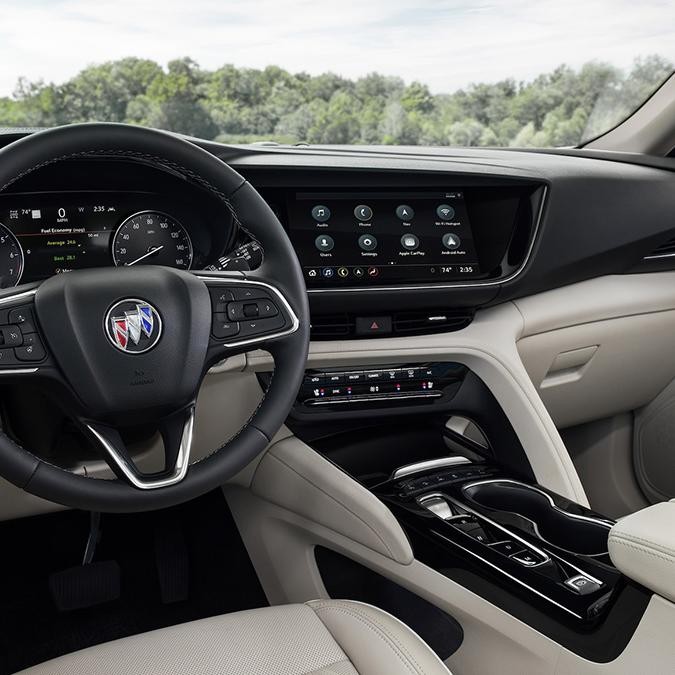 Interior view of a Buick Envision front seats and dashboard.