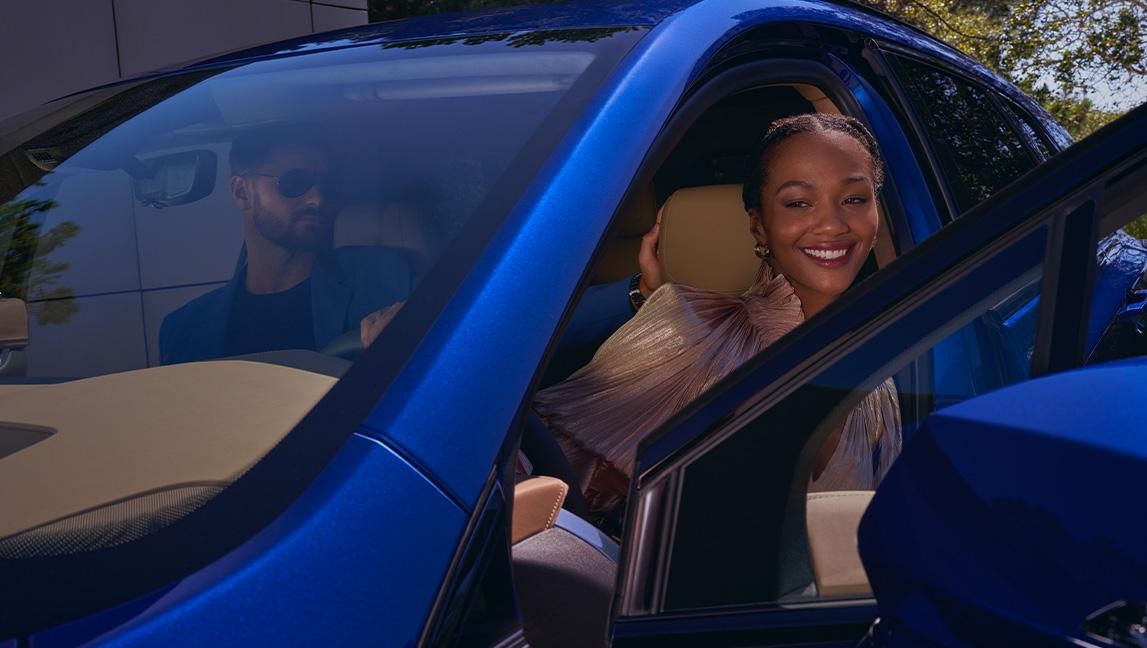 A Woman Exiting Her 2024 Cadillac XT5 Luxury SUV From the Driver's Side