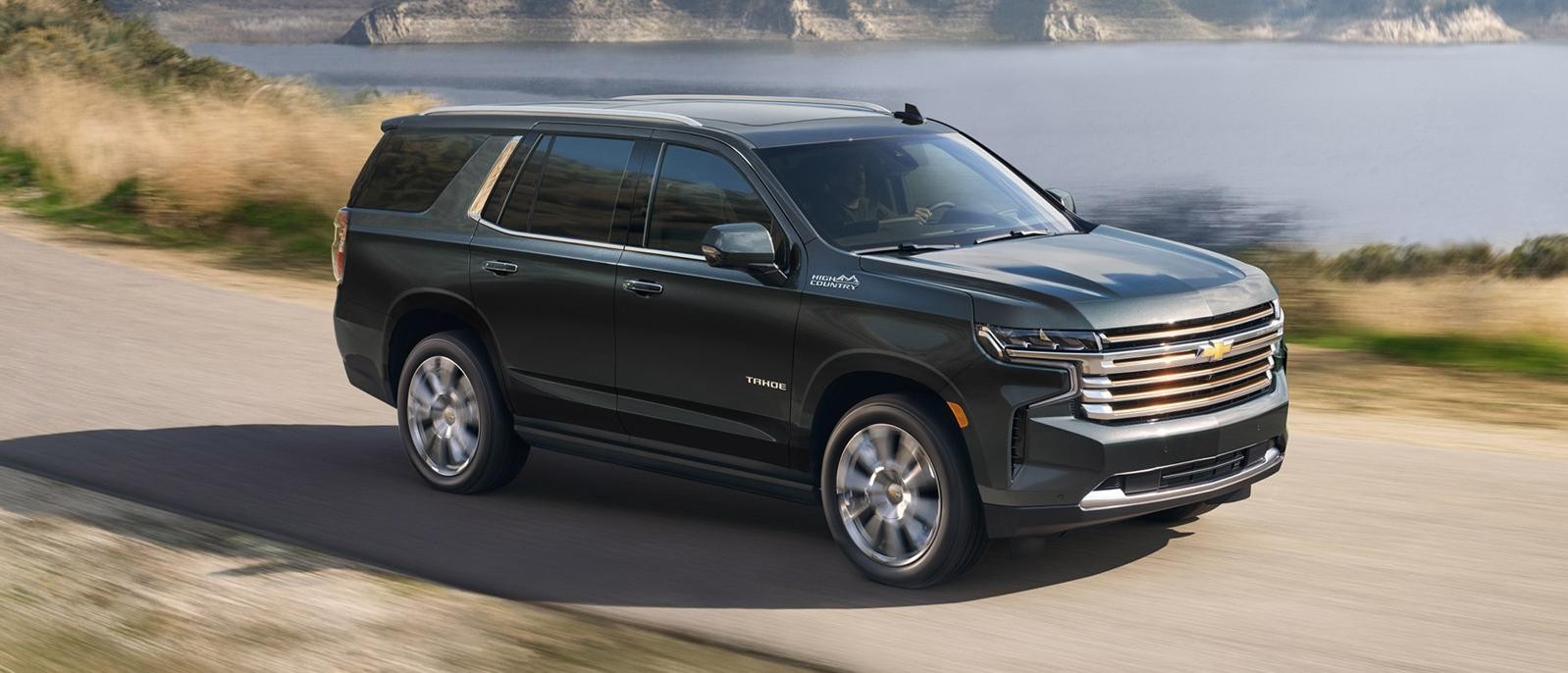 Chevrolet Tahoe cruising on a lakeside road