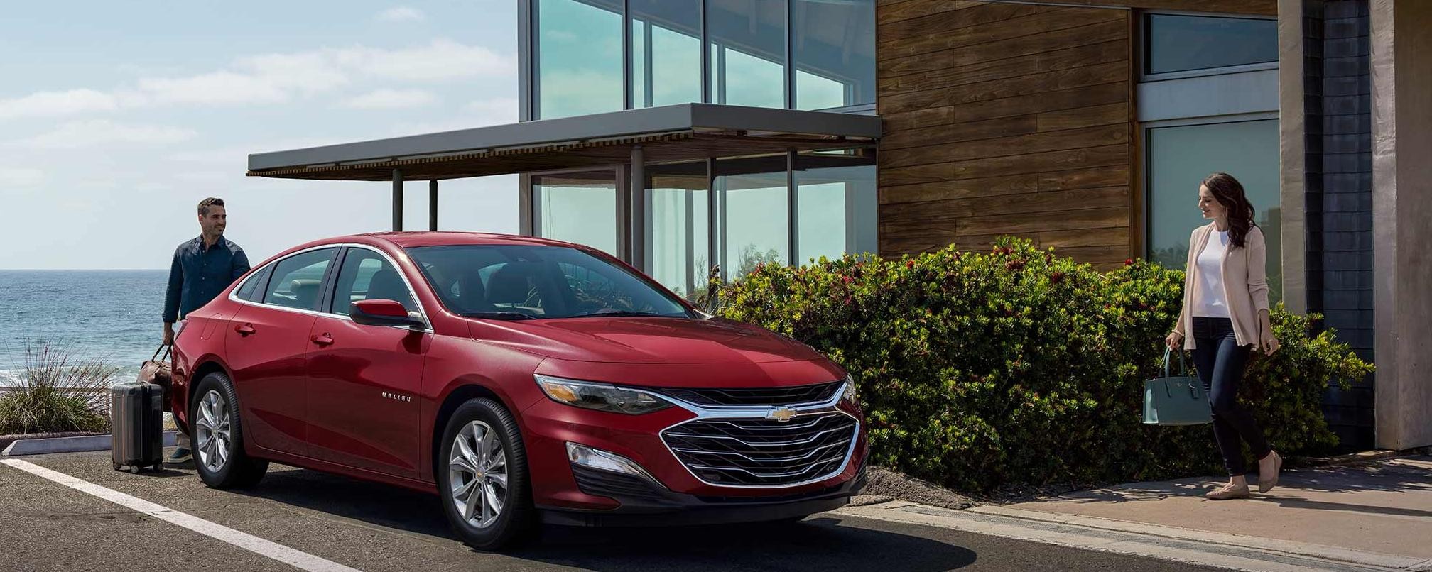 2023 Chevrolet Malibu parked in front of house.