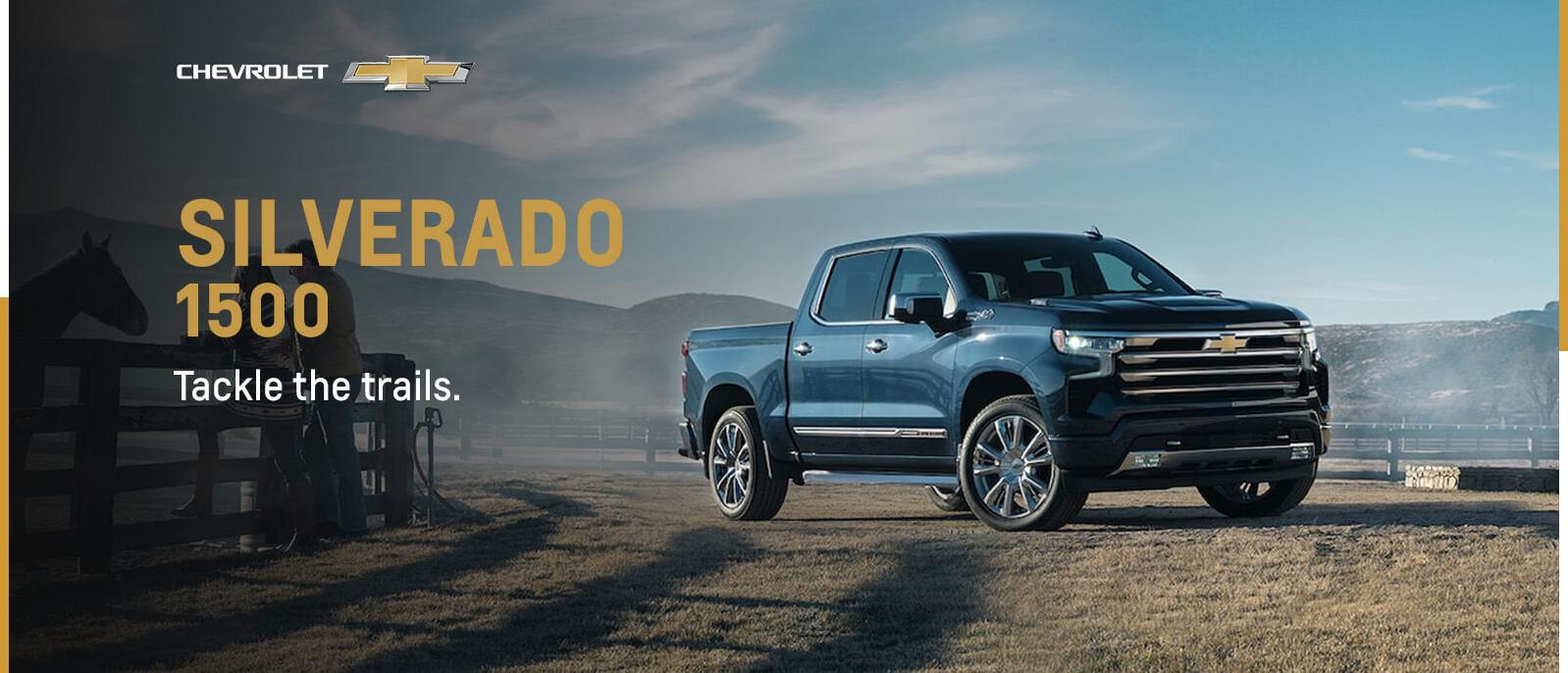 Black 2023 Silverado 1500 parked in open space with mountains in background Black 2023 Silverado 1500 parked in open space with mountains in background