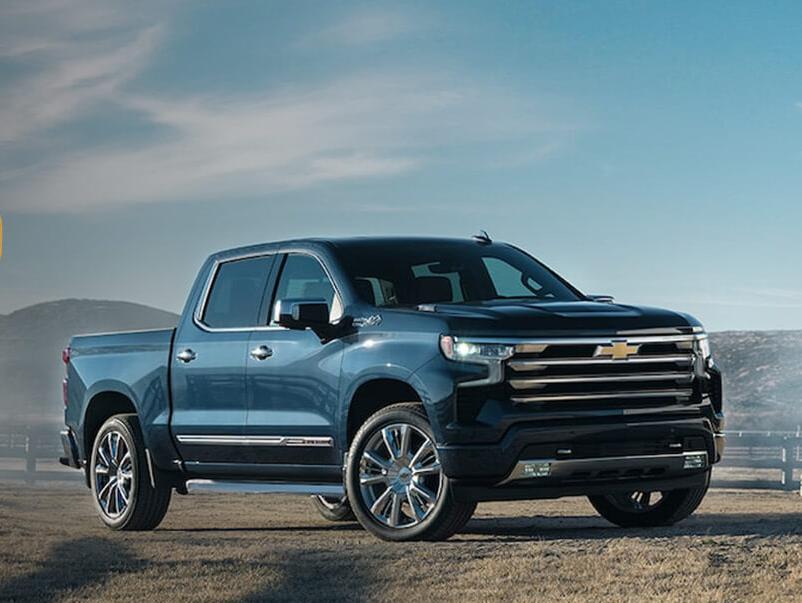 Black 2023 Silverado 1500 parked in open space with mountains in background