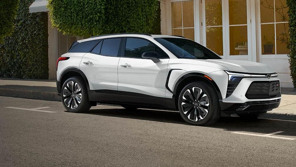 White 2024 Chevrolet Blazer EV is parked at roadside.