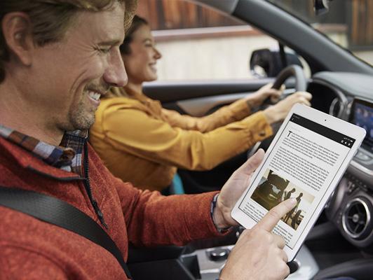 Man with tablet and woman driving Man with tablet and woman driving
