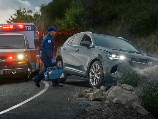 Crashed Buick with EMT on scene Crashed Buick with EMT on scene