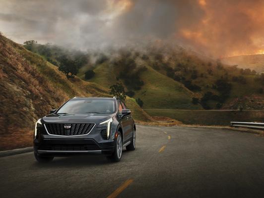 Cadillac driving away from fires in mountains Cadillac driving away from fires in mountains