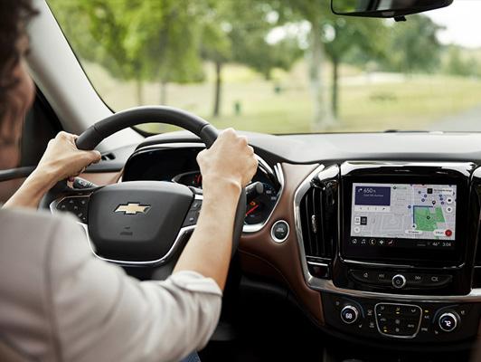 Woman driving chevy with navigation on screen Woman driving chevy with navigation on screen