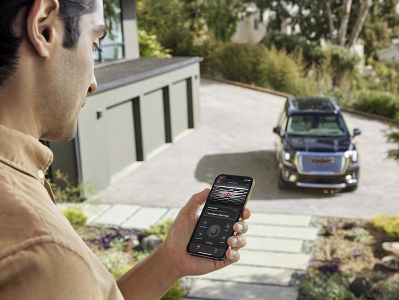 man on phone app looking at GMC vehicle man on phone app looking at GMC vehicle