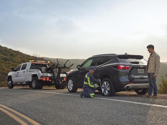 Truck and Equinox on road surrounded with mountains, And worker helping to tow car Truck and Equinox on road surrounded with mountains, And worker helping to tow car