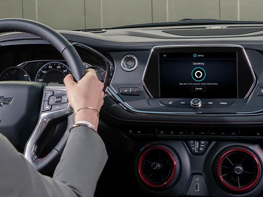 Woman driving with alexa on display Woman driving with alexa on display
