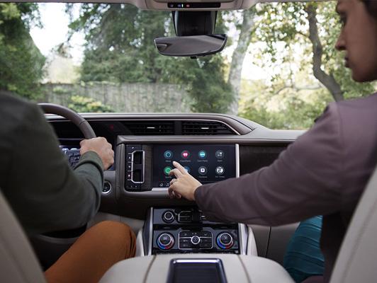man driving gmc and woman using in vehicle app man driving gmc and woman using in vehicle app