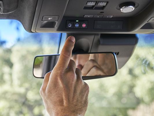 Man pushing onstar button on cadillac Man pushing onstar button on cadillac