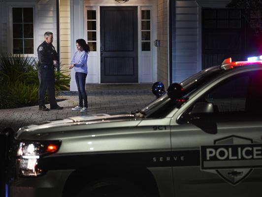 Police Officer talking to woman outside home Police Officer talking to woman outside home