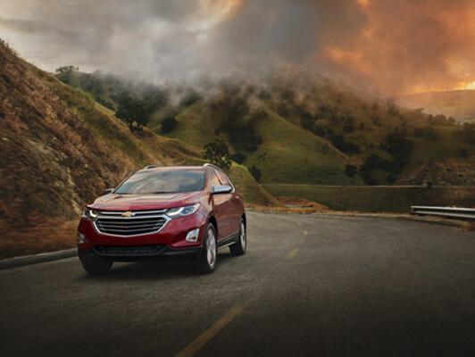 Red Equinox driving away from fire in mountains Red Equinox driving away from fire in mountains