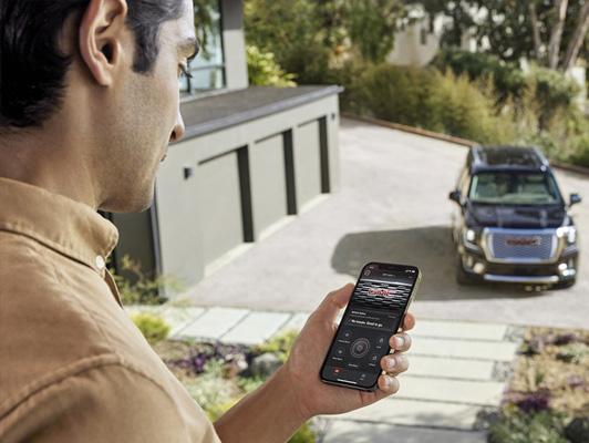 man on phone app looking at GMC vehicle man on phone app looking at GMC vehicle