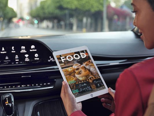 woman using tablet in car woman using tablet in car