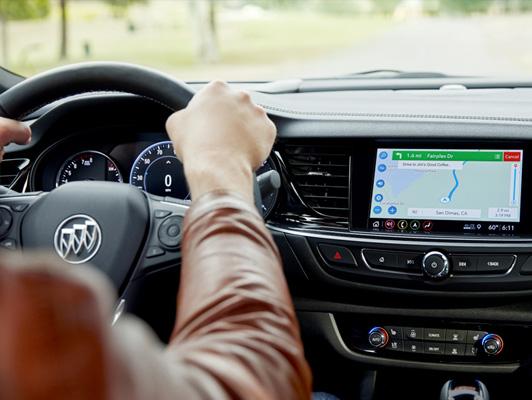 Woman driving Buick with navigation on screen Woman driving Buick with navigation on screen