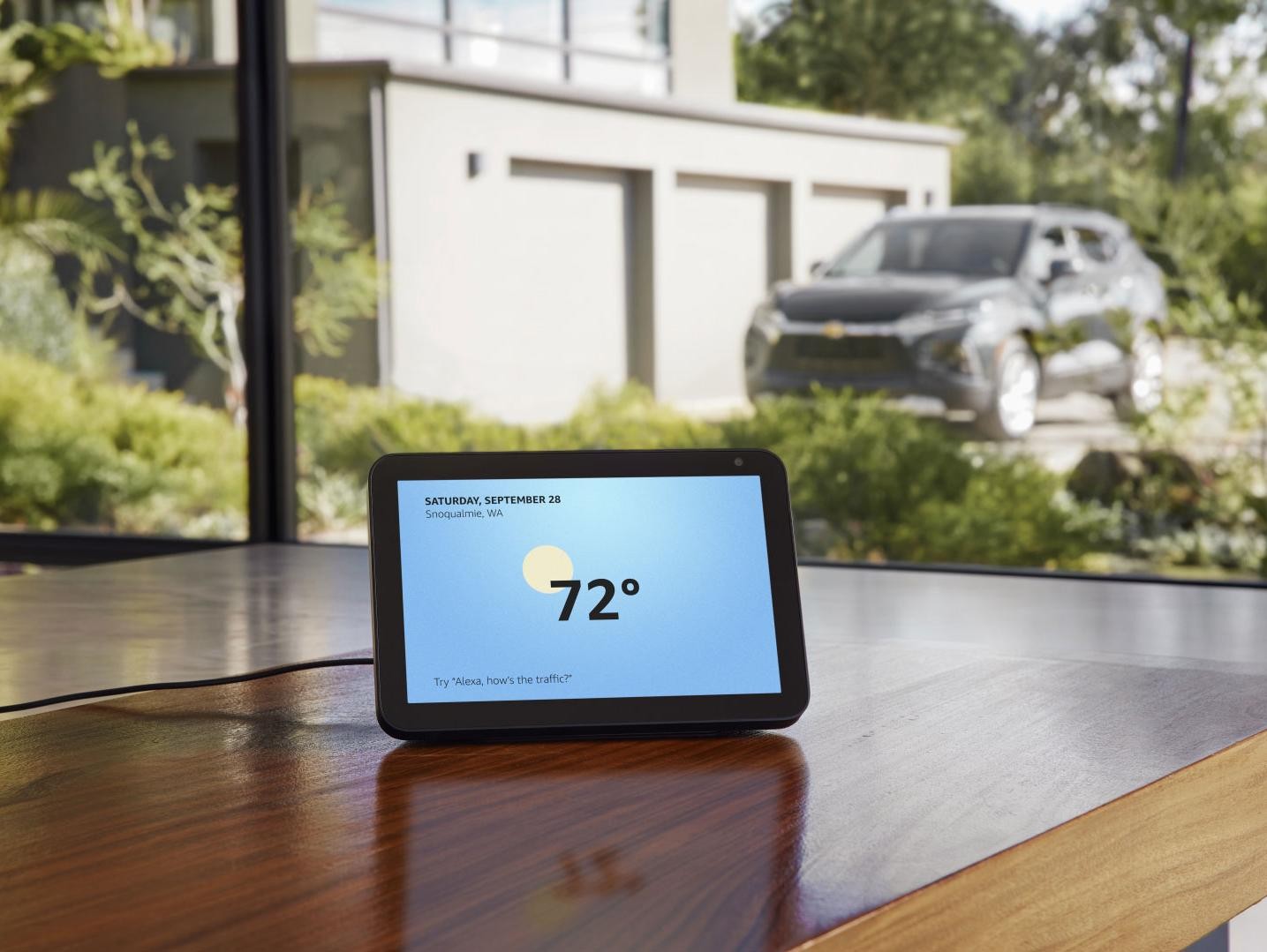 Tablet on the table with the car in the background.