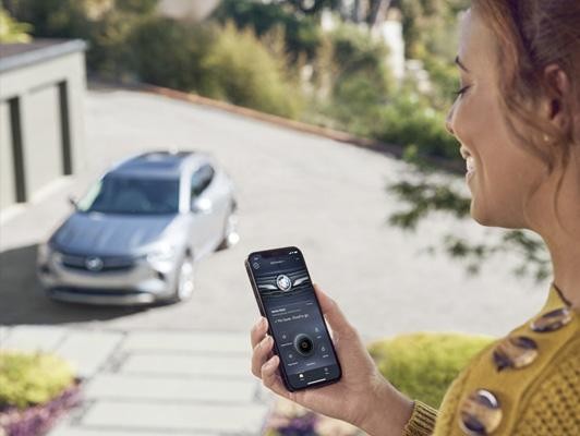 Woman on Buick App with Buick in Background