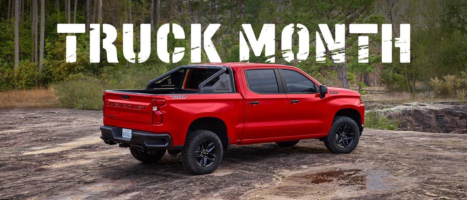 Red Silverado in Forrest with Truck Month logo Overlayed