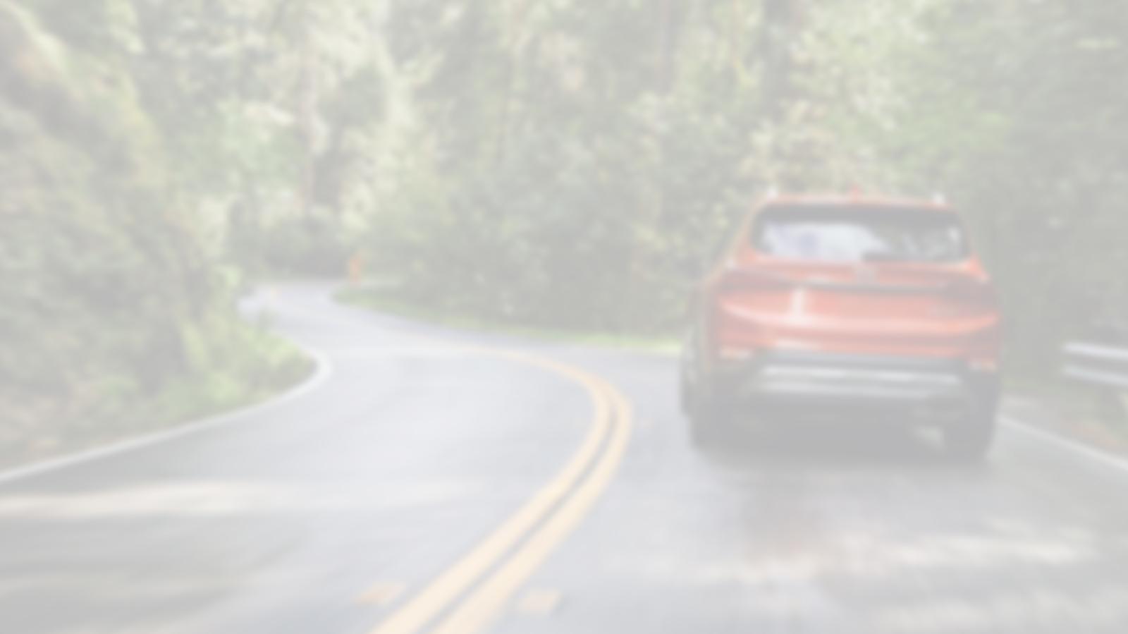 Hyundai Santa Fe driving down a road.