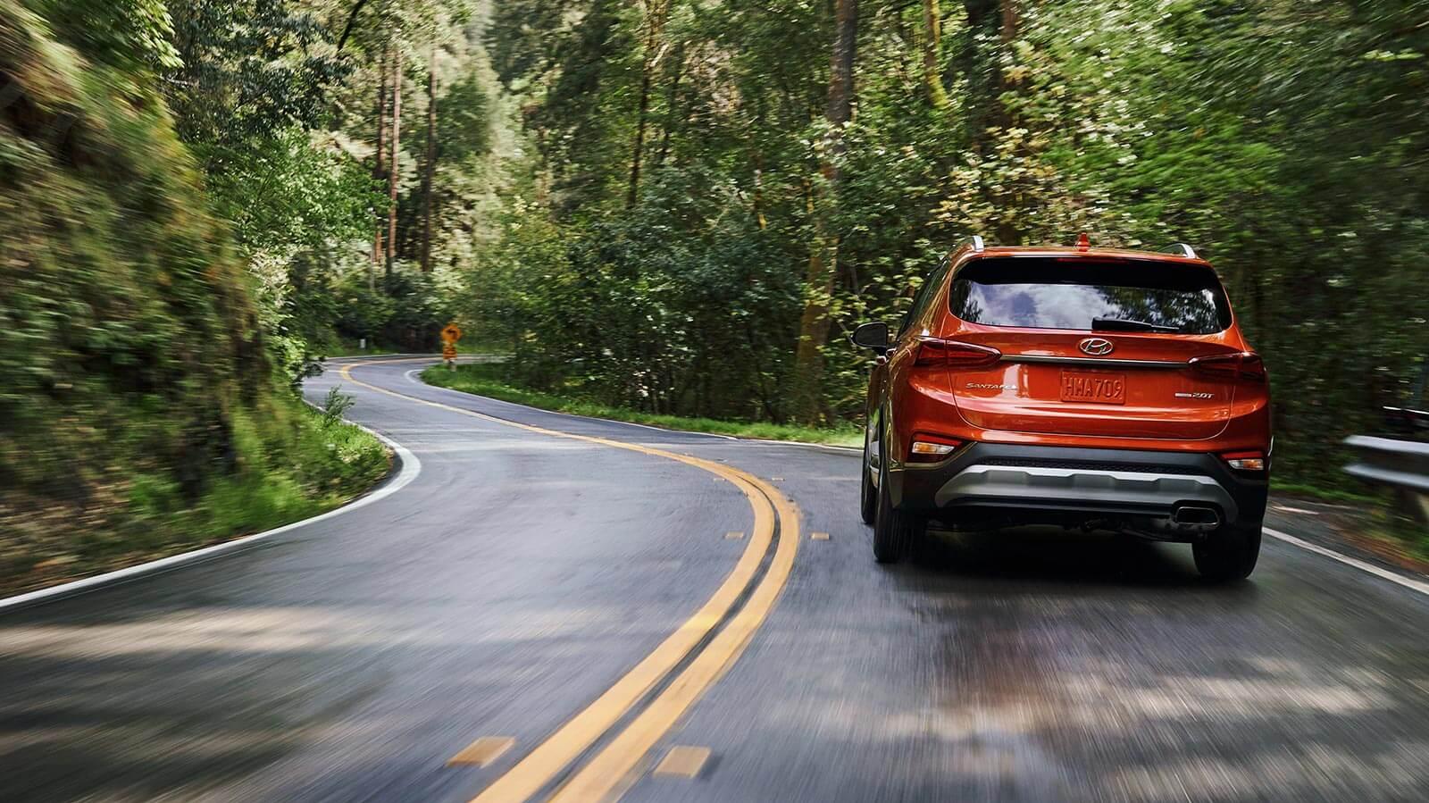 Hyundai Santa Fe driving down a road.