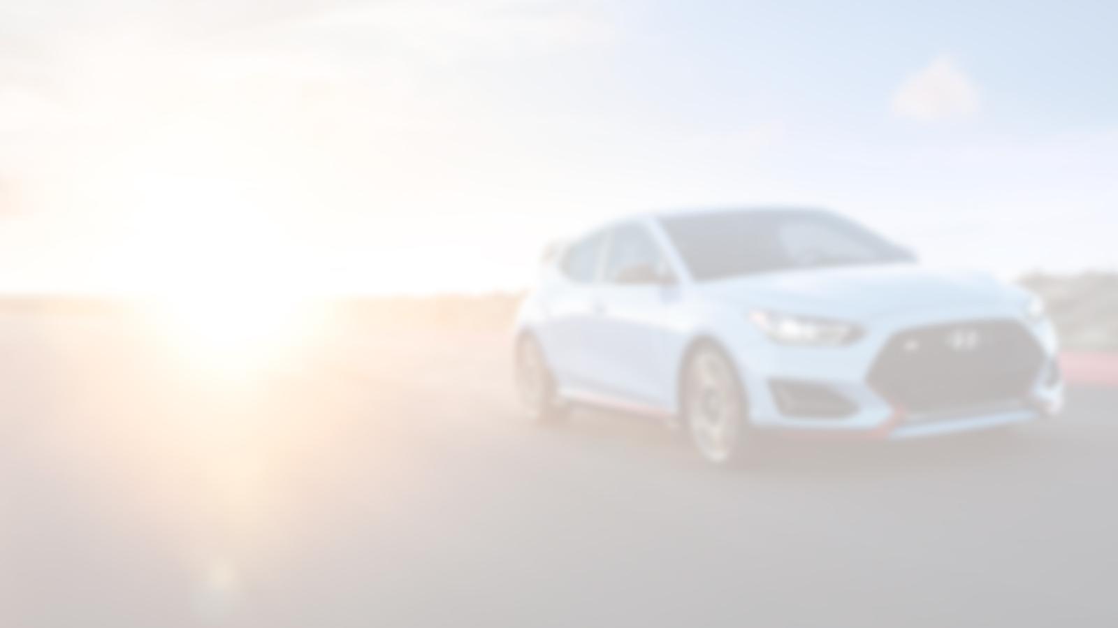 Hyundai Veloster racing on a track.