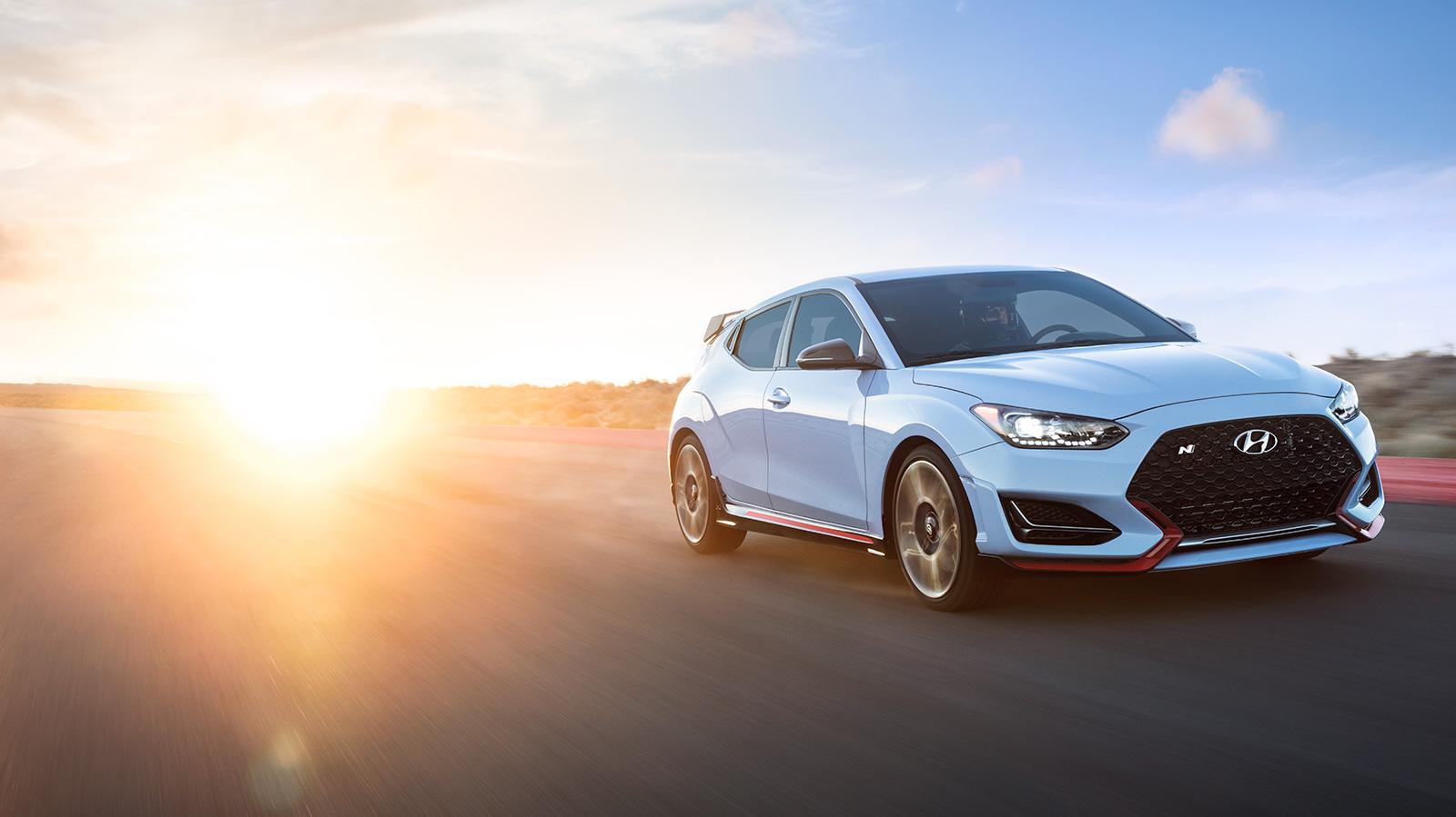 Hyundai Veloster racing on a track.