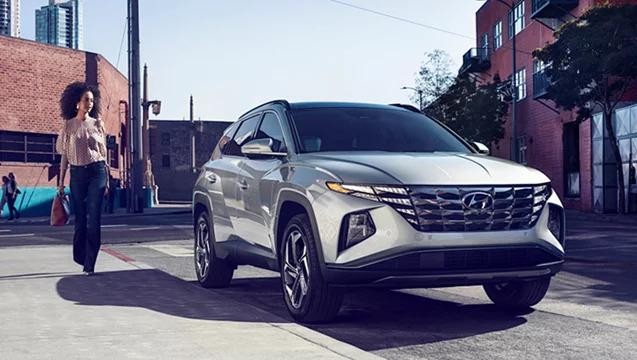 Woman walking towards a Silver Hyundai