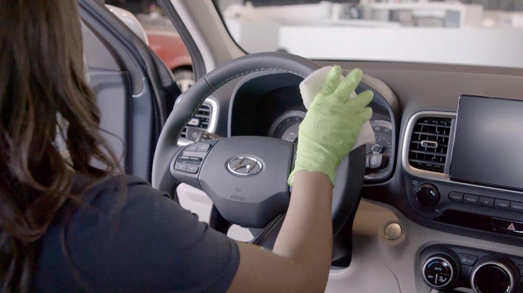 Woman disinfecting a Hyundai vehicle