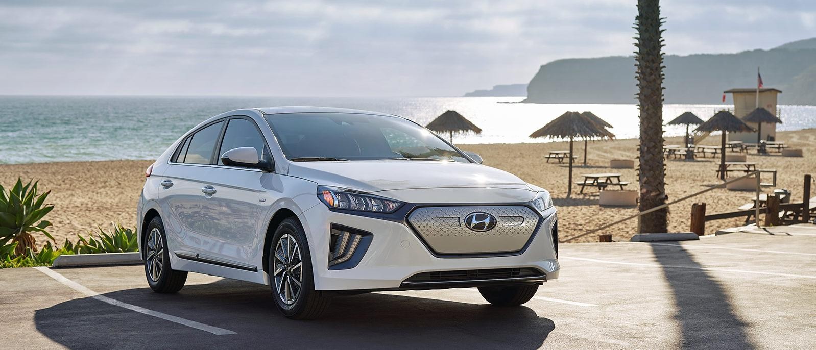 A white Hyundai Ioniq Electric parked at the beach.