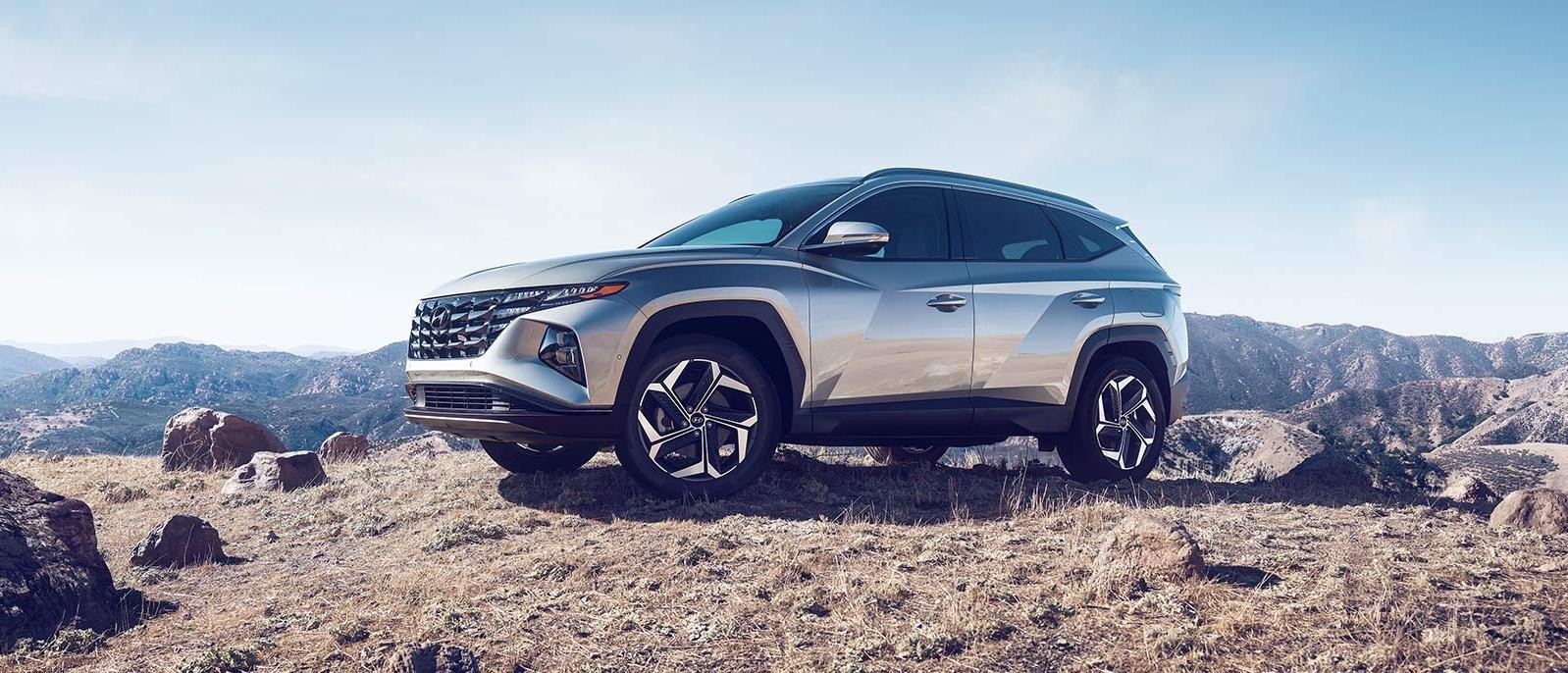 Silver 2022 Hyundai Tucson is parked on the mountain.