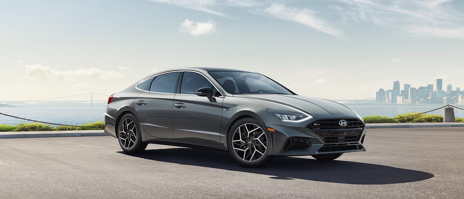The 2022 Hyundai Sonata is parked in the parking with beautiful scenery in the background.