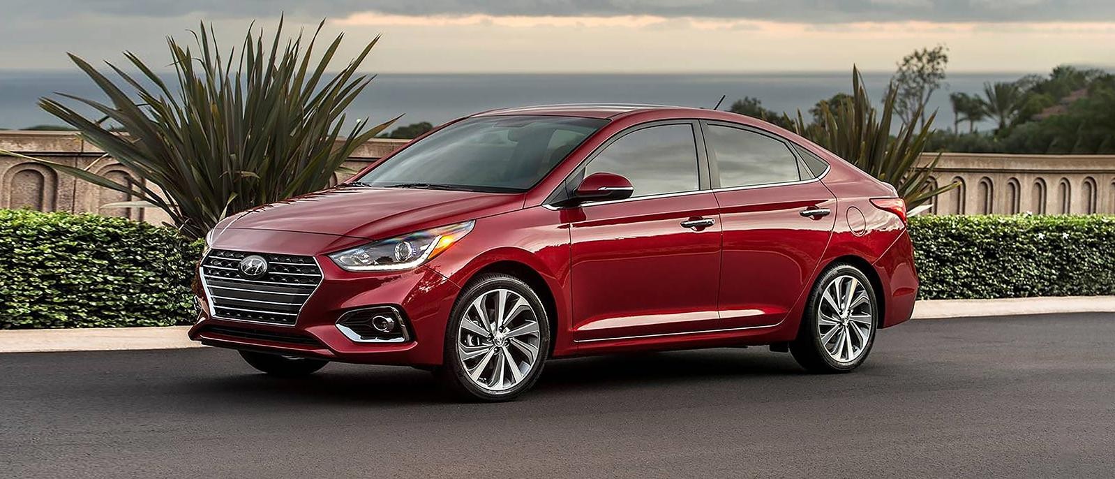 A Red Hyundai Accent Parked on a street.