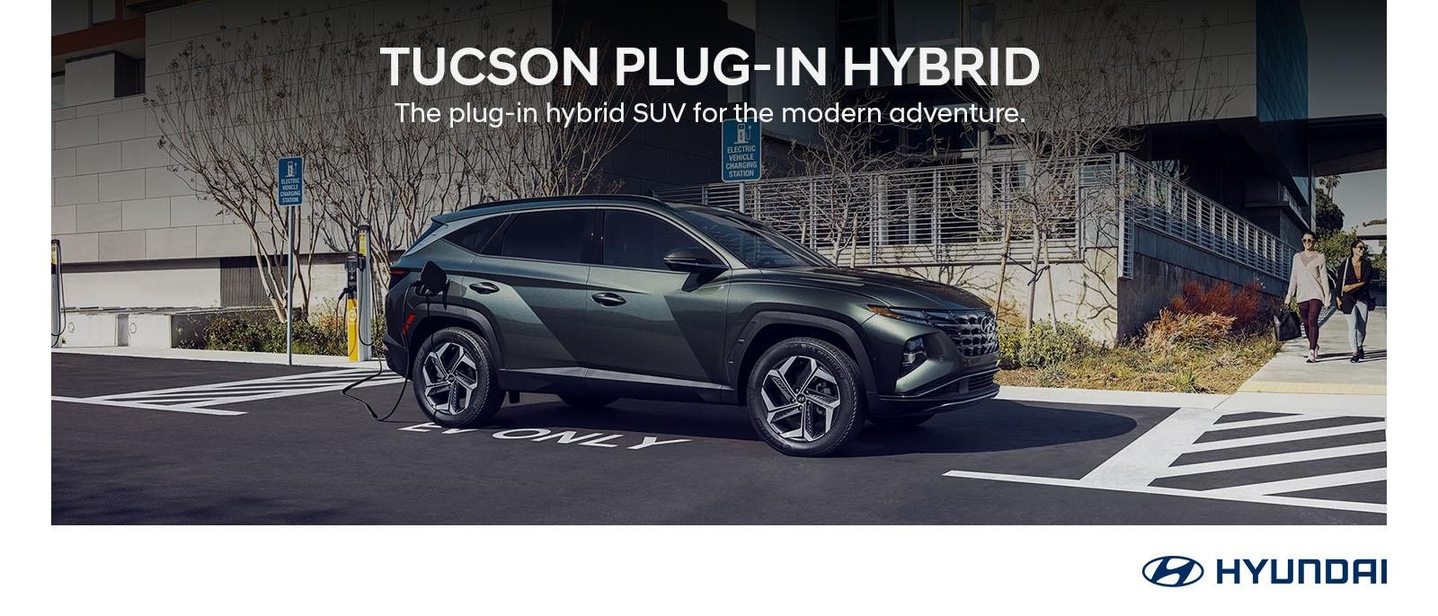 2024 Hyundai TUCSON Plug-in Hybrid parked with buildings in background.