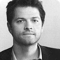 Black & white portrait of Misha Collins.
