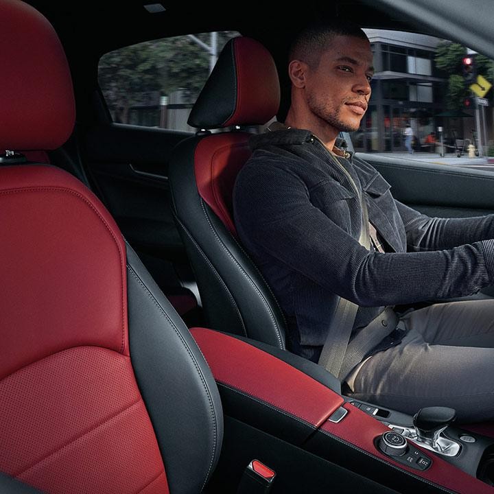 A man behind the wheel of an INFINITI QX55.