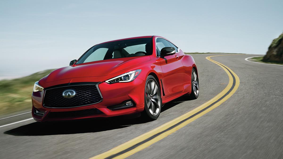 A red Q60 driving along a seaside highway. A red Q60 driving along a seaside highway.
