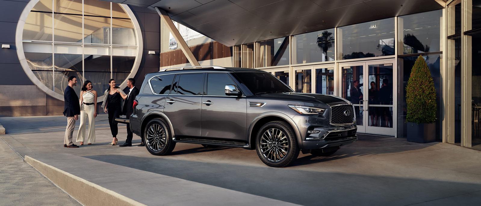 Graphite Shadow INFINITI QX80 parked outside a glass building Graphite Shadow INFINITI QX80 parked outside a glass building