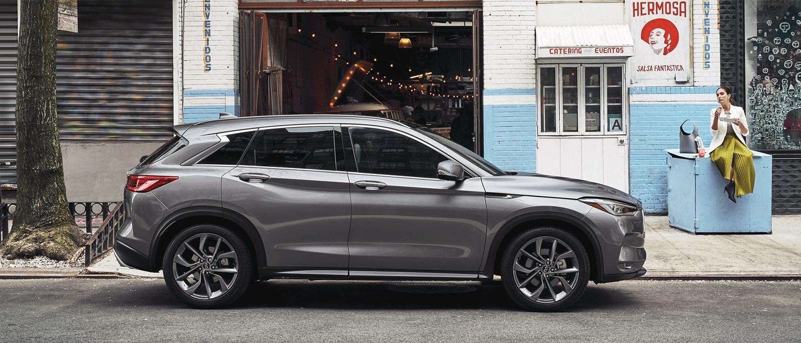 Profile view of an INFINITI QX50 parked in front of a restaurant. Profile view of an INFINITI QX50 parked in front of a restaurant.