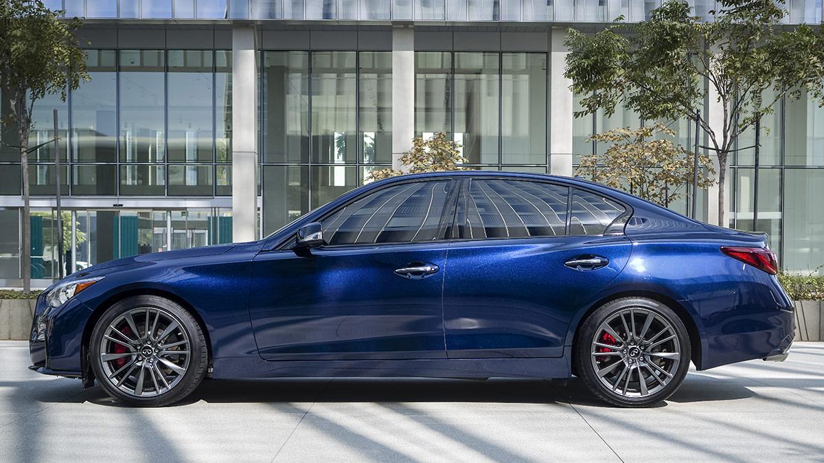 Profile view of a blue INFINITI Q50 parked in front of a building in the city. Profile view of a blue INFINITI Q50 parked in front of a building in the city.