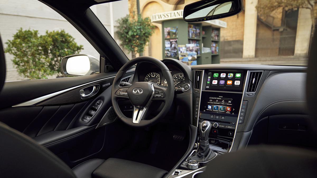 Interior view of an INFINITI Q50 with black upholstery in the city. Interior view of an INFINITI Q50 with black upholstery in the city.