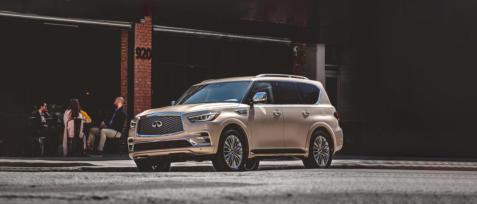 A QX80 champagne quartz Parked in front of a Restaurant A QX80 champagne quartz Parked in front of a Restaurant